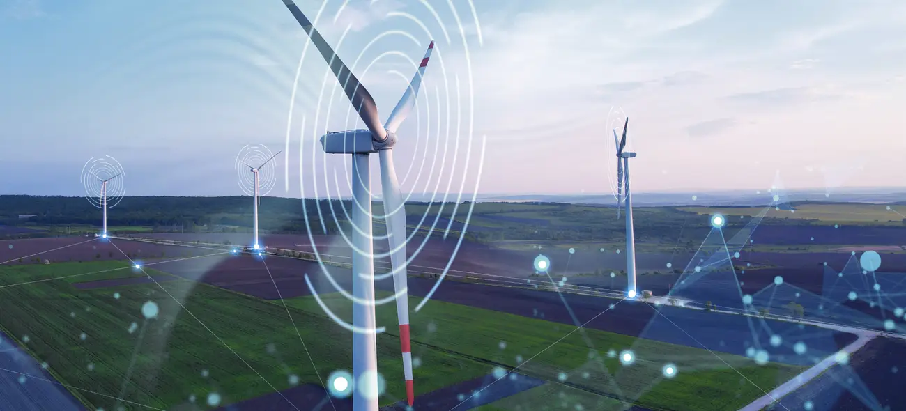 Windräder in grüner Landschaft mit überlagerten Grafiken und Datenpunkten.